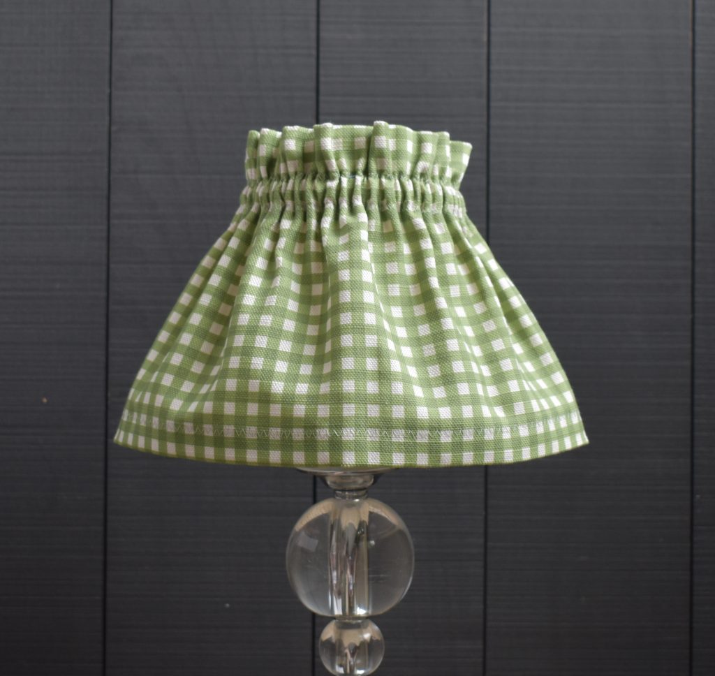 This is Dolly our Dolly Green Gingham Scrunchie Lampshade This a two piece set, the cover and the lampshade. underneath The cover slips on top easily, gathers beautifully and can be removed for hand washing. It is slightly bigger than the lampshade underneath. It is designed to be prouder at the top and longer at the base. Dimensions are shown in CM as Base Diameter x Top Diameter x Height
