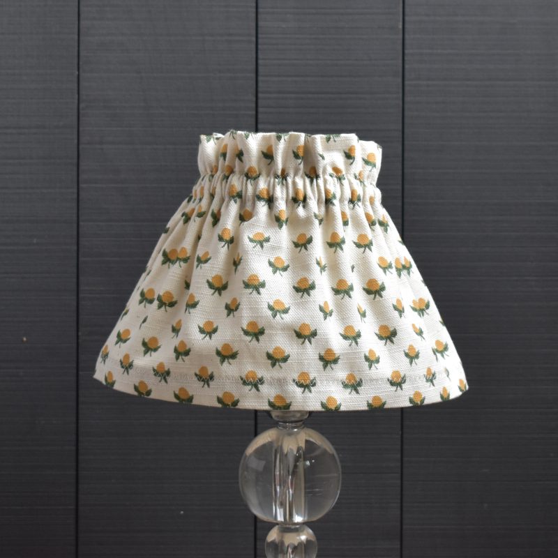 Dolly Floral Orange Bud Scrunchie Lampshade This a two piece set, the cover and the lampshade underneath. The cover slips on top easily, gathers beautifully and can be removed for hand washing. It is slightly bigger than the lampshade underneath. It is designed to be prouder at the top and longer at the base.